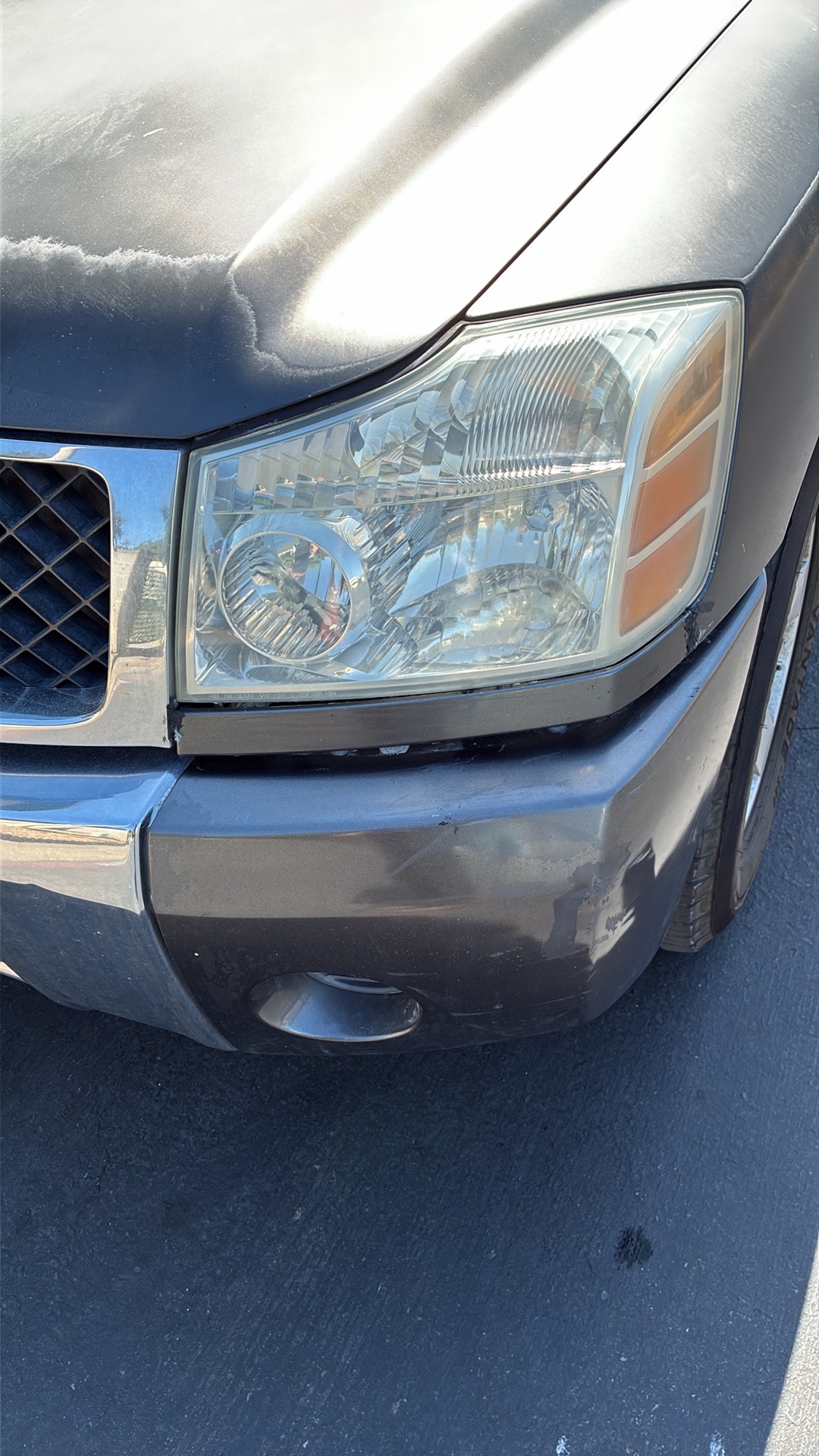 Foggy oxidized headlight on a Nissan Titan before Detail X headlight restoration — Sacramento & Placer County