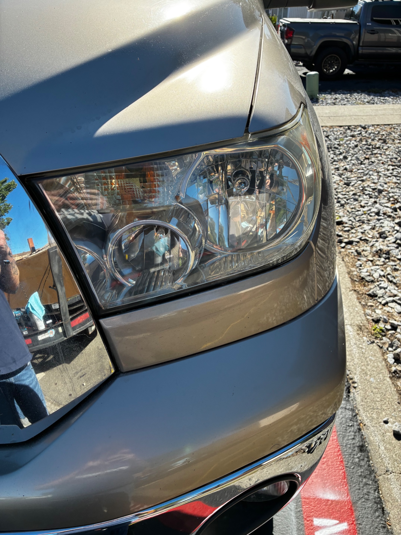 Same Toyota headlight after Detail X restoration — crystal-clear lens with sharp reflections
