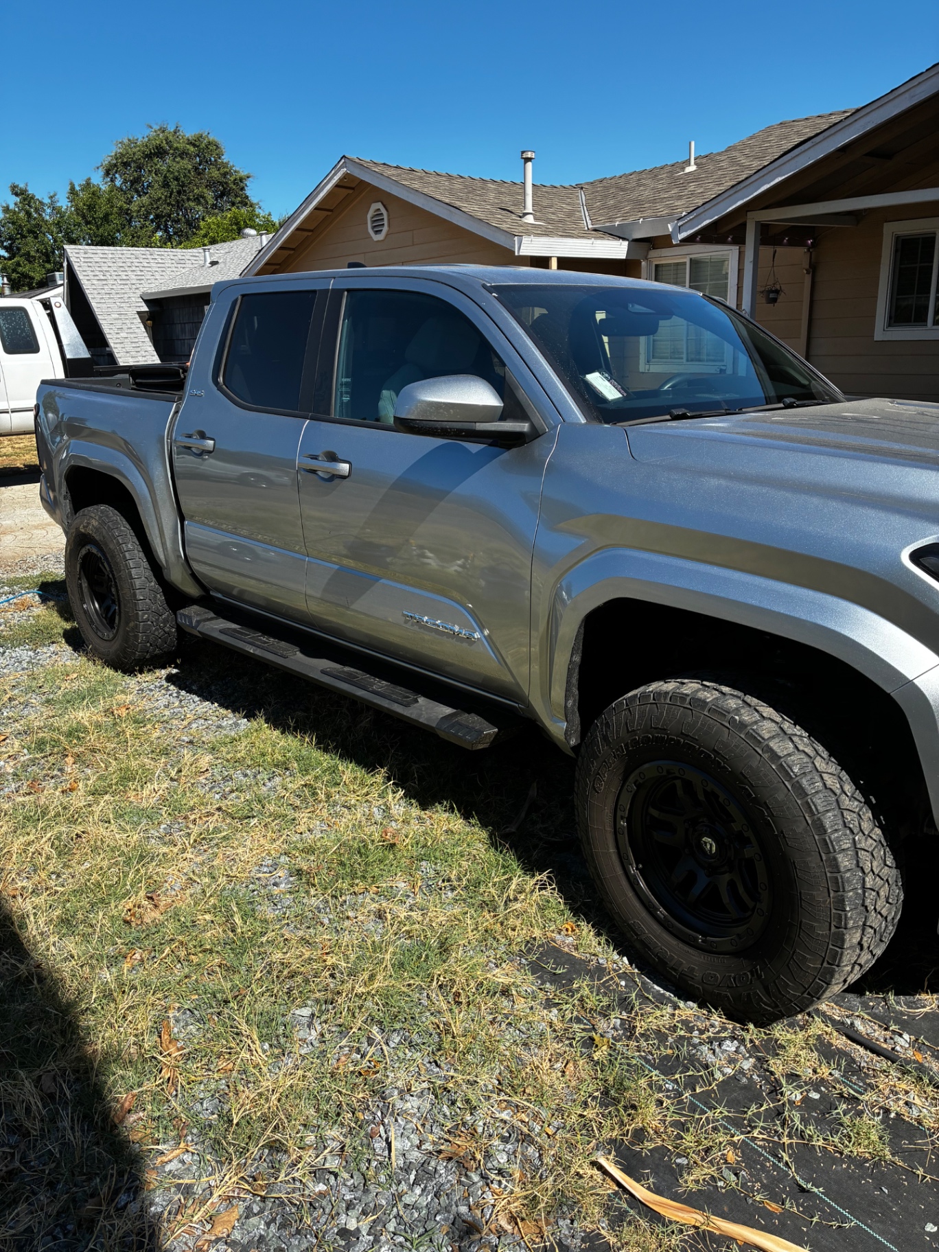 Silver Toyota Tacoma driver-side profile with glossy paint and clean wheels after mobile detail