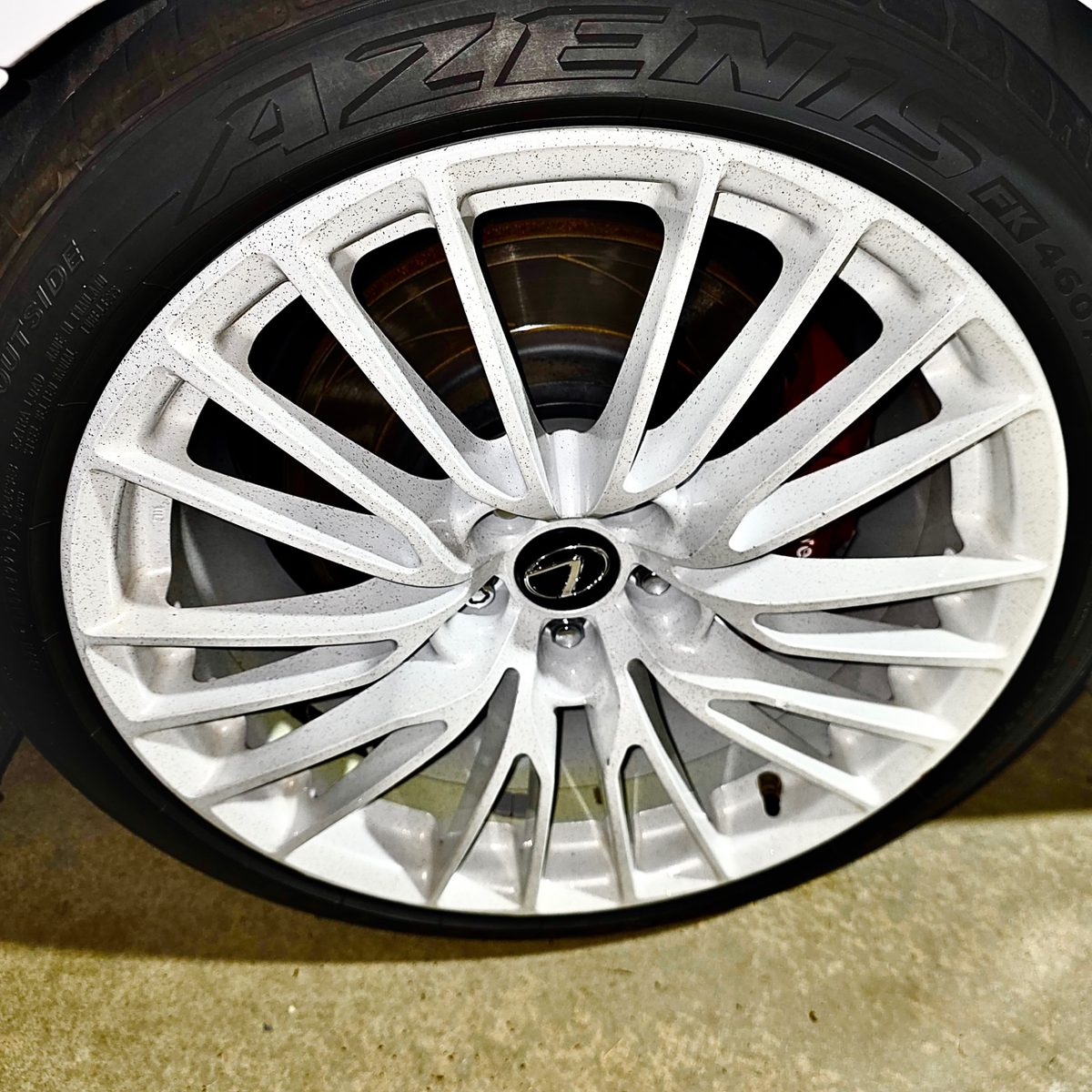 Lexus wheel with red brake caliper after ceramic wheel coating by Detail X in Sacramento & Placer County