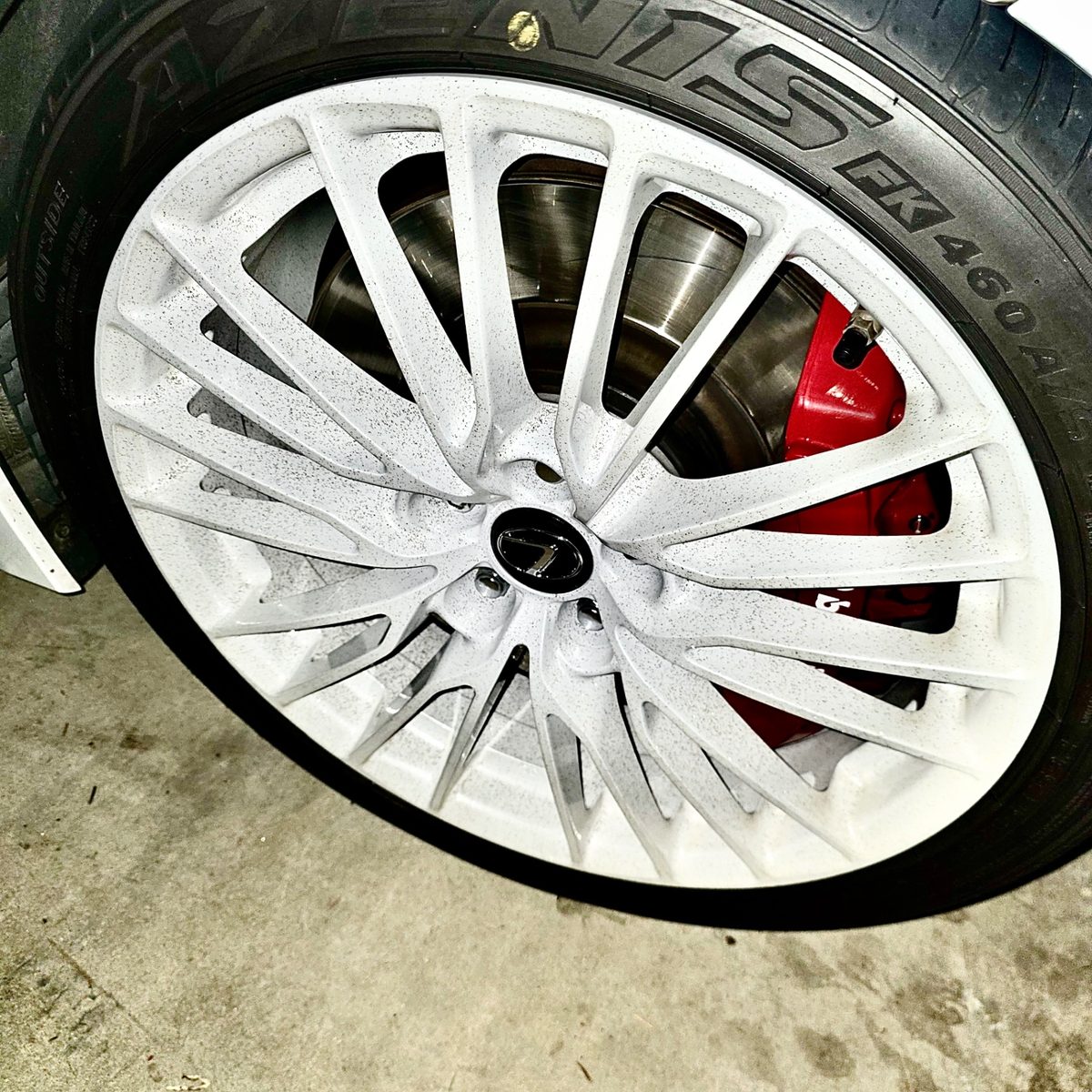 Close-up angle of ceramic-coated Lexus wheel showing gloss finish and red caliper — Detail X mobile detailing